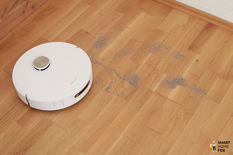 Dreame X40 Ultra Complete убирает песок на ламинате во время теста.